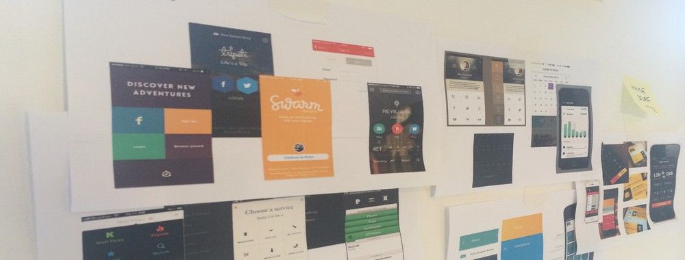 A selection of UI design patter printouts stuck to a whiteboard.