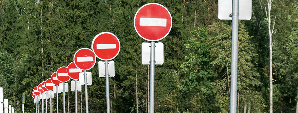 A series of stop signs along a road